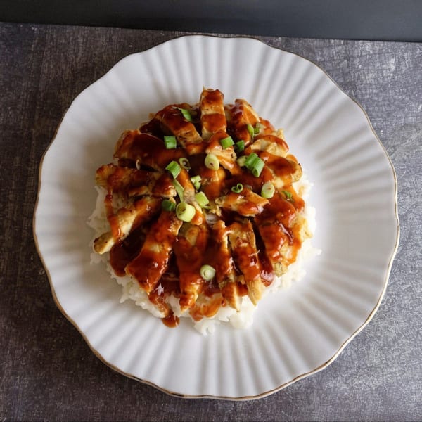 Thai Chili's chicken teriyaki, served over white rice and garnished with chopped green onions.